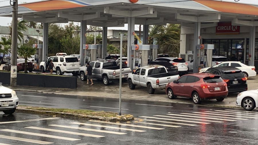Motorists wait in a long line to purchase fuel at a Circle K/76 gas station at the corner of Marine Corps Drive and Ypao Road in Tamuning, Guam, Thursday, May 25, 2023, in the aftermath of Typhoon Mawar.
