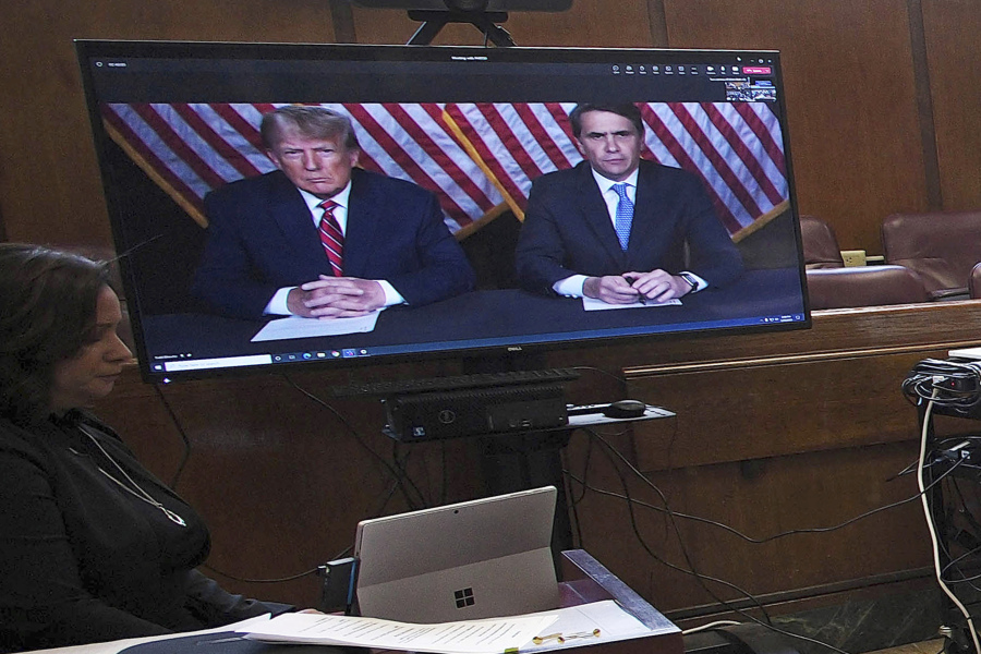 FILE - Former President Donald Trump, left on screen, and his attorney, Todd Blanche, right on screen, appear by video before a hearing begins in Manhattan criminal court, in New York, May 23, 2023. Trump speaks about his legal woes in a way that would make most defense attorneys wince. The former president has never hesitated to offer his opinion or joust with his antagonists. But legal experts say Trump's freewheeling speaking style could give prosecutors additional ammunition to use against him in court.