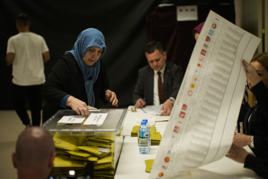 A woman votes at a polling station in Istanbul, Turkey, Sunday, May 14, 2023. Voters in Turkey go to the polls on Sunday for pivotal parliamentary and presidential elections that are expected to be tightly contested and could be the biggest challenge Turkish President Recep Tayyip Erdogan faces in his two decades in power.