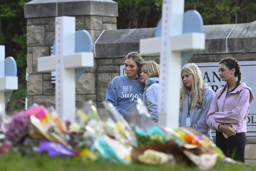 FILE - Students at a nearby school pay respects at a memorial for the people who were killed, at an entry to Covenant School, Tuesday, March 28, 2023, in Nashville, Tenn. Six people were killed at the private school and church yesterday by a shooter. The U.S. is setting a record pace for mass killings in 2023, replaying the horror in a deadly loop roughly once a week so far this year. The bloodshed overall represents just a fraction of the deadly violence that occurs in the U.S. annually.