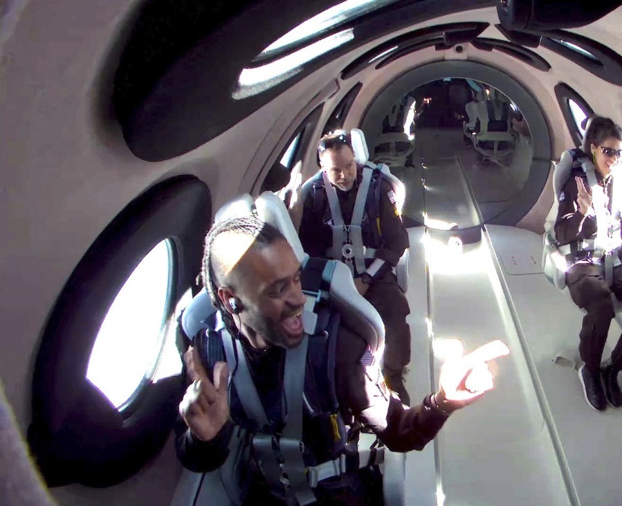 This photo released by Virgin Galactic shows mission specialist Christopher Huie, left, instructor Luke Mays, center, and mission specialist Jamila Gilbert during a test flight on Thursday, May 25, 2023. Virgin Galactic completed what's expected to be its final test flight Thursday before taking paying customers on brief trips to space.