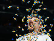 Seattle Mariners' Cal Raleigh smiles as a teammate throws bubble gum at him during an interview after Raleigh hit a single to drive in the winning run against the New York Yankees during the 10th inning of a baseball game Wednesday, May 31, 2023, in Seattle.