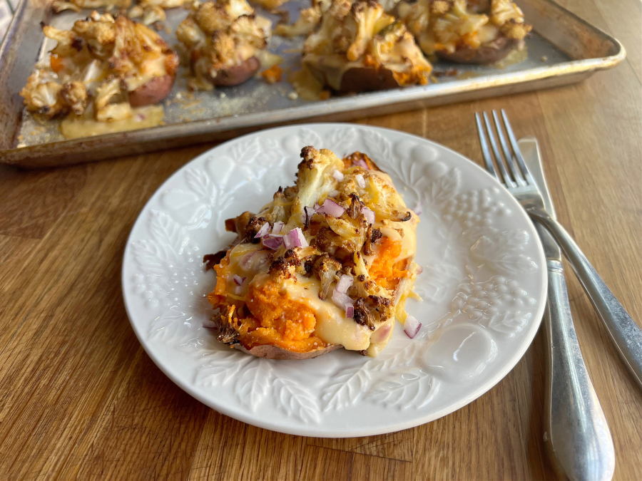 Sweet potatoes stuffed with cheesy, roasted cauliflower make a quick and easy vegetarian dinner.