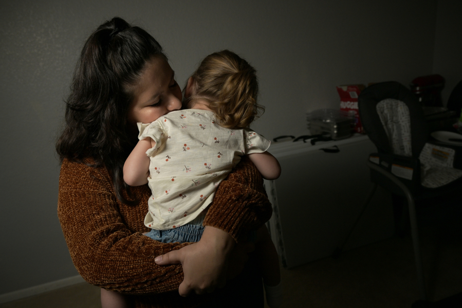 Brittany Diekneit holds her daughter, Milani Byrne, 2, at Diekneit's mother's home in Denver on May 5, 2023. Diekneit is facing a charge of knowingly/recklessly killing her newborn baby after co-sleeping.