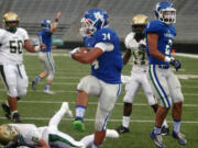 Mountain View running back Taj Albeck scores against Auburn in the 2015 Emerald City Kickoff Classic at Husky Stadium in Seattle. The state football championship games will be held at Husky Stadium at the end of the 2023 season.