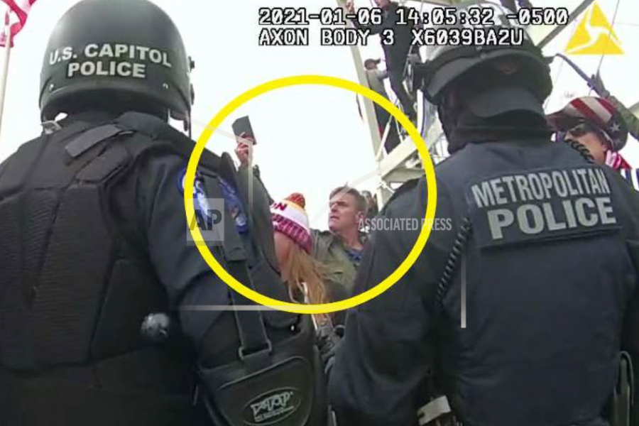 This image from Washington Metropolitan Police Department body-worn video, released and annotated by the Justice Department in the statement of facts supporting an arrest warrant for Jay James Johnston, shows Johnston, circled in yellow, at the U.S. Capitol on Jan. 6, 2021, in Washington. Johnston, the actor known for his roles on the comedy television shows "Bob's Burgers" and "Mr. Show with Bob and David" has been arrested on charges that he joined a mob of Donald Trump supporters in confronting police officers during the U.S. Capitol riot.