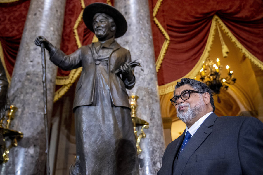 Sculptor Littleton Alston poses Wednesday in front of his congressional statue of Willa Cather following its unveiling in Statuary Hall on Capitol Hill in Washington. Willa Cather was one of the country's most beloved authors, writing about the Great Plains and the spirit of America.