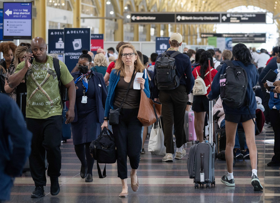 Passengers check in for their flights at the start of the Memorial Day weekend at Reagan National Airport in Arlington, Virginia on May 26, 2023.