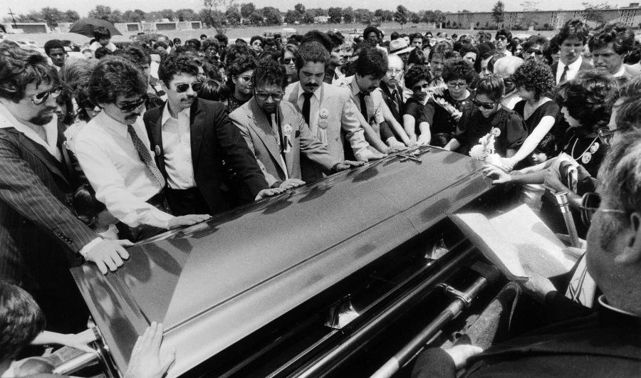 People place hands on the casket carrying Rudy Lozano's body before his burial at St. Mary?s Cemetery at 87th Street and Hamlin Avenue in Evergreen Park on June 13, 1983.