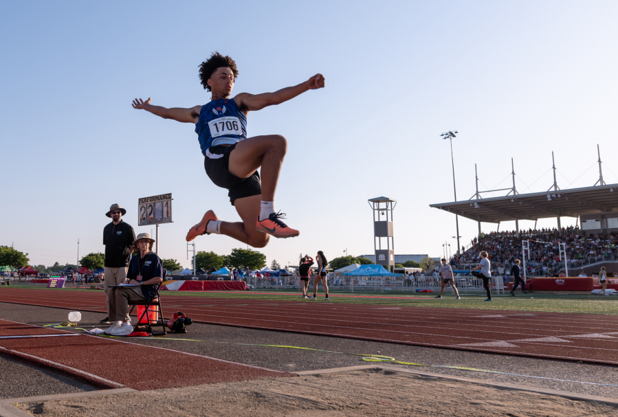 Ridgefield's Landon Kelsey leaps in the finals of the long jump at the WIAA 2A/3A/4A State Track and Field Championships on Thursday, May 25, 2023, at Mount Tahoma High School in Tacoma.
