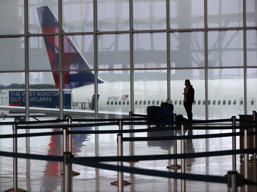 A Delta plane sits at the International Terminal at Hartsfield Jackson International Airport on March 16, 2020, in Atlanta.