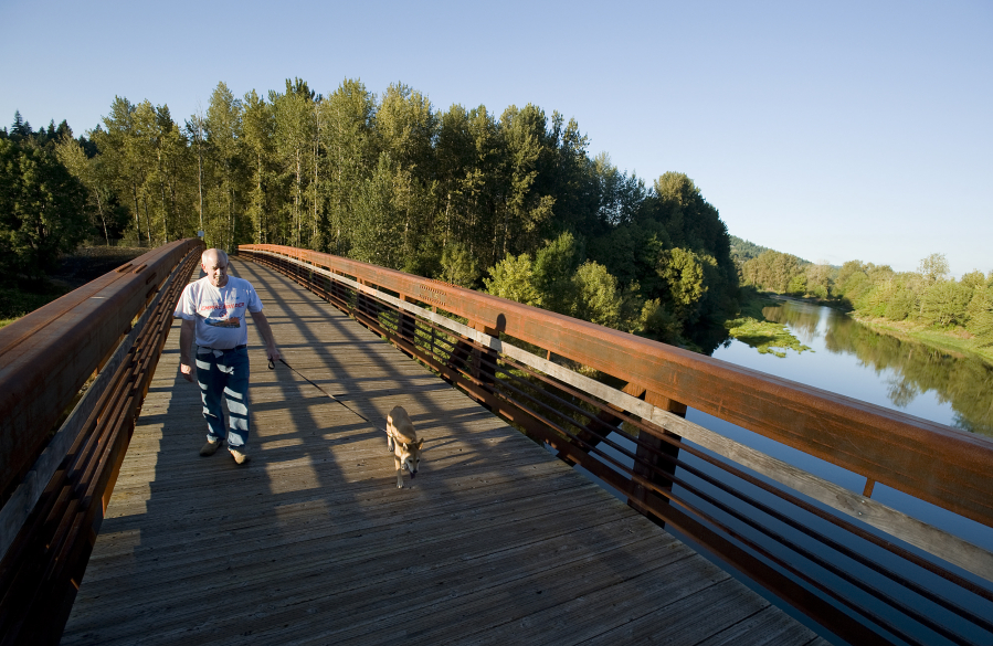 Nelson Switzer and his dog Lucy use the Washougal River Greenway trail in Camas in 2010.