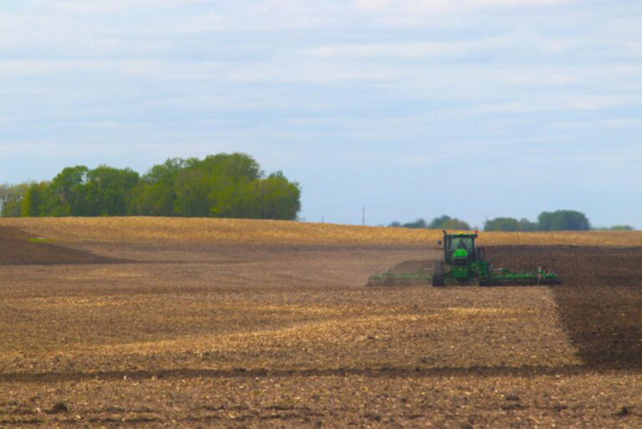 A farmer tends a field, preparing for spring planting, in rural west-central Minnesota.