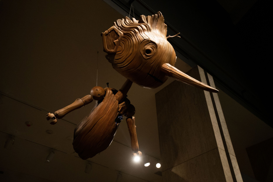 A large-scale version of Pinocchio hovers over an entrance to the "Guillermo del Toro: Crafting Pinocchio" exhibit at the Portland Art Museum.