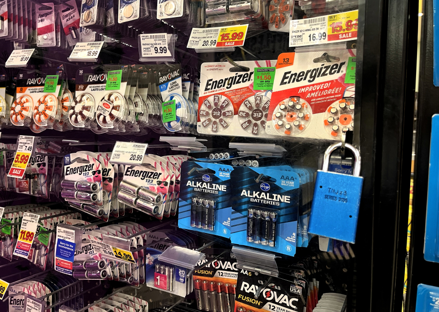 Batteries are locked up behind a glass showcase at a grocery store in Calabasas, California, in October 2022. Retail chains are adding more security measures to combat retail theft.