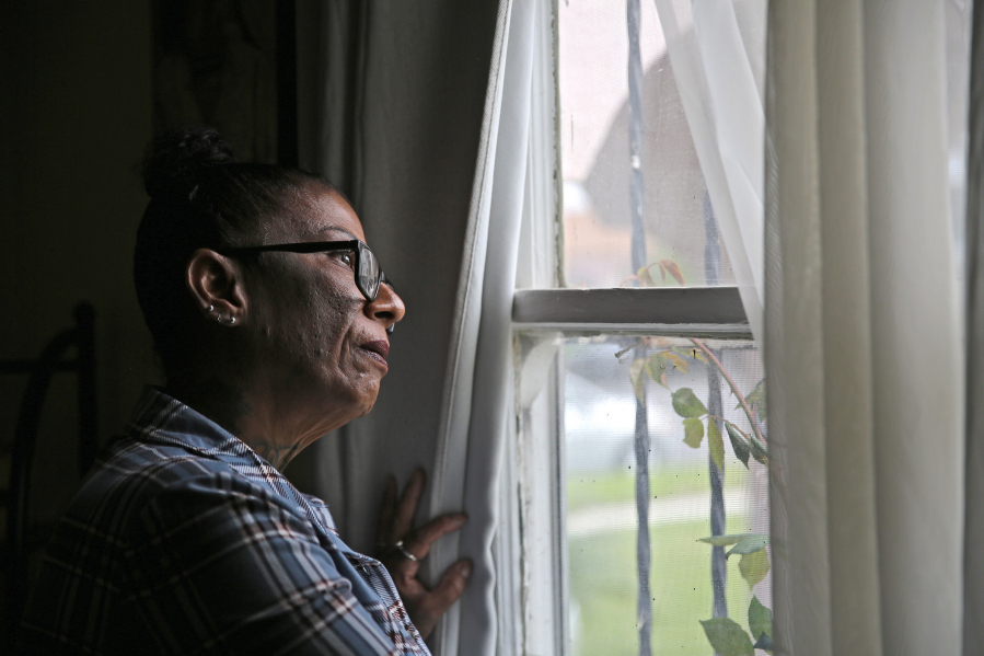 Deana Mirabal of Los Angeles poses for a photo as she looks out a window of a reintegration home she lives in, on Sunday, April 16, 2023, in Los Angeles.