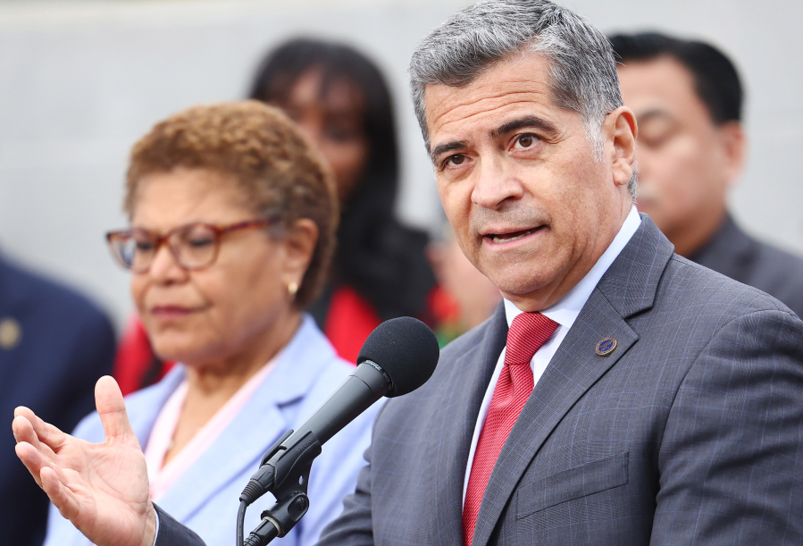 U.S. Health and Human Services Secretary Xavier Becerra speaks as Los Angeles Mayor Karen Bass looks on at a news conference following a tour and roundtable discussion at an Asian American Drug Abuse Program facility on May 31, 2023, in Los Angeles.