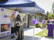 Andrea Brooks, president and CEO of Lifeline Connections, left, speaks during an opening ceremony for their new involuntary treatment program as director of involuntary treatment Raven Mosley loos on at the Crisis Wellness Center on Thursday.