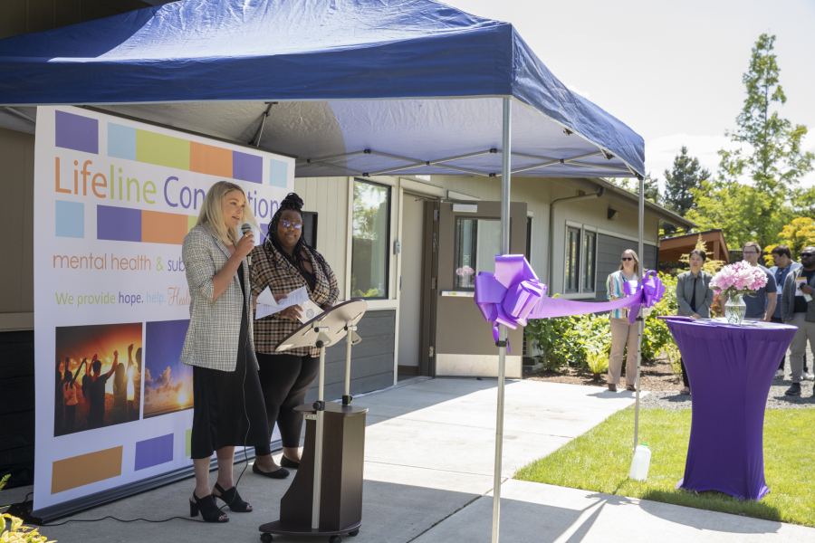 Andrea Brooks, president and CEO of Lifeline Connections, left, speaks during an opening ceremony for their new involuntary treatment program as director of involuntary treatment Raven Mosley loos on at the Crisis Wellness Center on Thursday.