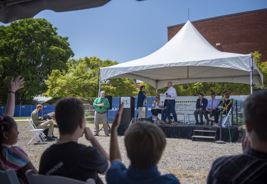 At left, people applaud and listen to speakers Thursday during a groundbreaking ceremony for the Center for Deaf and Hard of Hearing Youth at Washington School for the Deaf. The school will open a new academic building and gymnasium in 2024 -- the school's first major construction in 50 years.