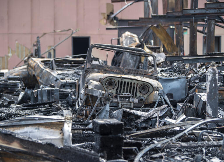 A burned Jeep sits inside the charred remains of a building Wednesday, June 7, 2023, at Whipple Creek Business Park in Salmon Creek. No one was injured in the two-alarm fire that started late Tuesday night, but at least seven businesses were destroyed.