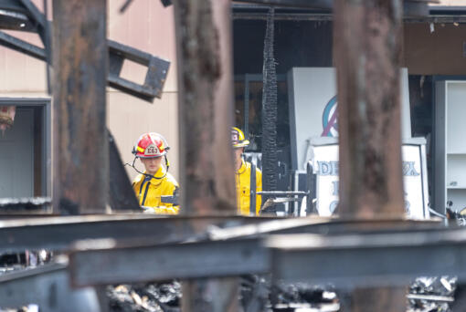 Clark County Fire District 6 firefighters walk around the site of a fire Wednesday, June 7, 2023, at Whipple Creek Business Park in Salmon Creek. No one was injured in the two-alarm fire that started late Tuesday night, but at least seven businesses were destroyed.
