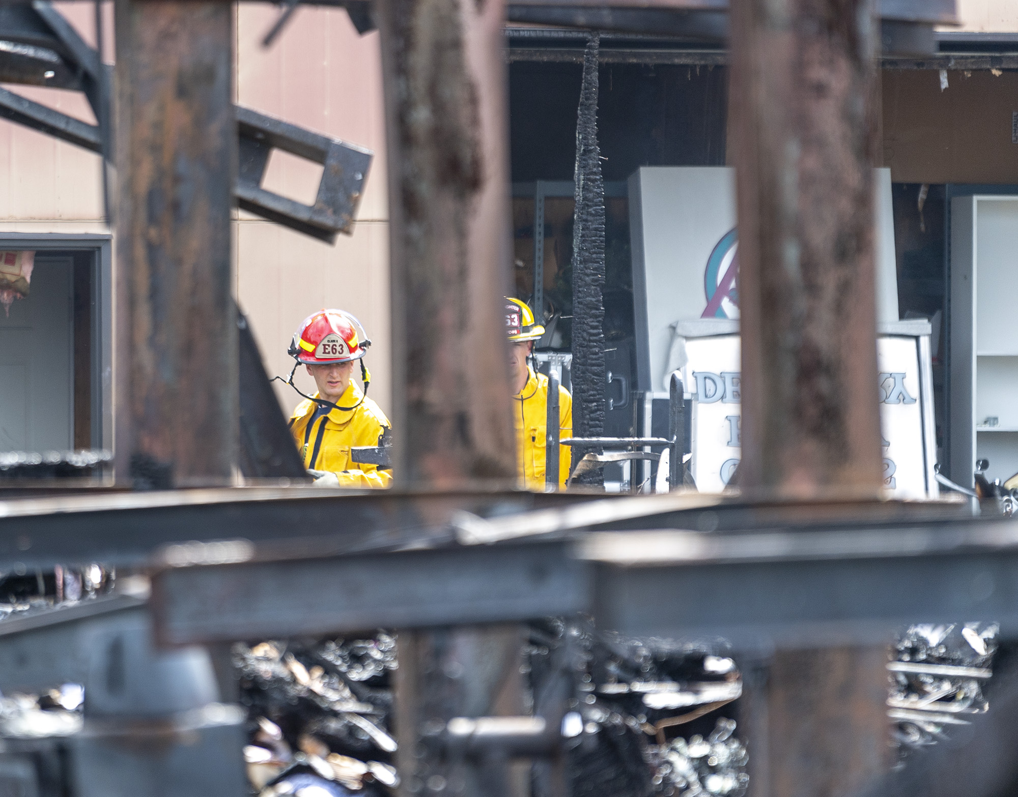 Clark County Fire District 6 firefighters walk around the site of a fire Wednesday, June 7, 2023, at Whipple Creek Business Park in Salmon Creek. No one was injured in the two-alarm fire that started late Tuesday night, but at least seven businesses were destroyed.