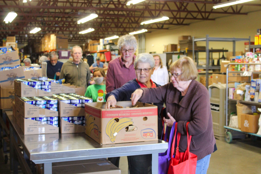 On the last day of the Backpack Program until fall, volunteers worked in an efficient assembly line to stuff tote bags full of nonperishable food. The bags would then be loaded into cars and delivered to 85 schools across the county.