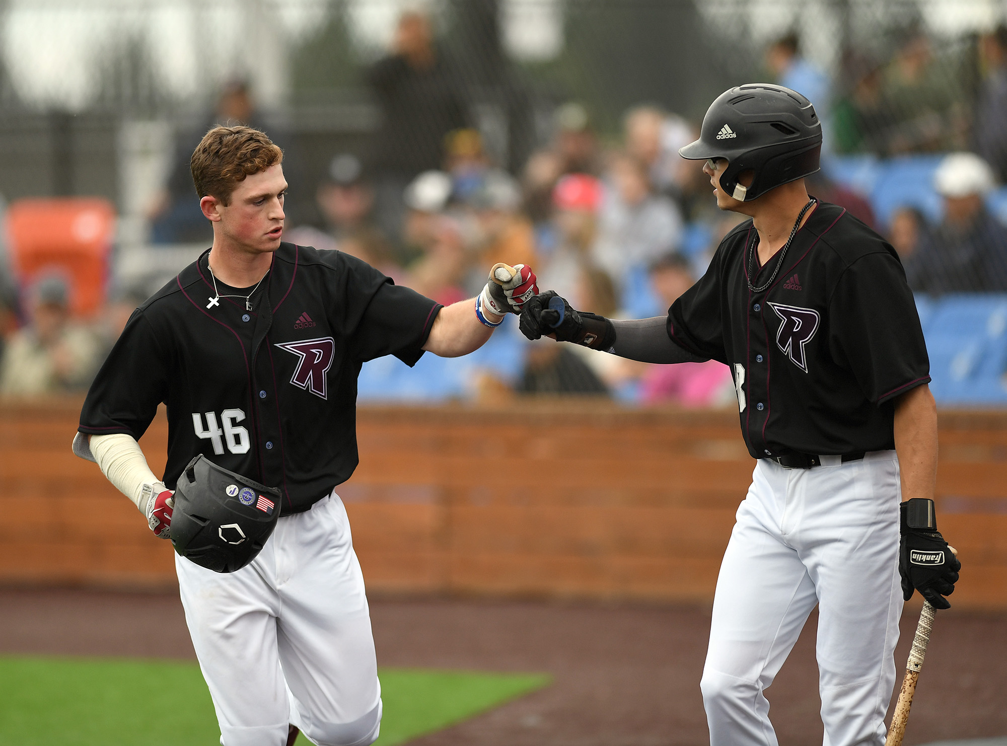 Raptors player Jackson Nicklaus, left, fist bumps teammate Nick Seamons after Nicklaus hit a home run Friday, June 16, 2023, during the Raptors’ game against Cowlitz at the Ridgefield Outdoor Recreation Complex.