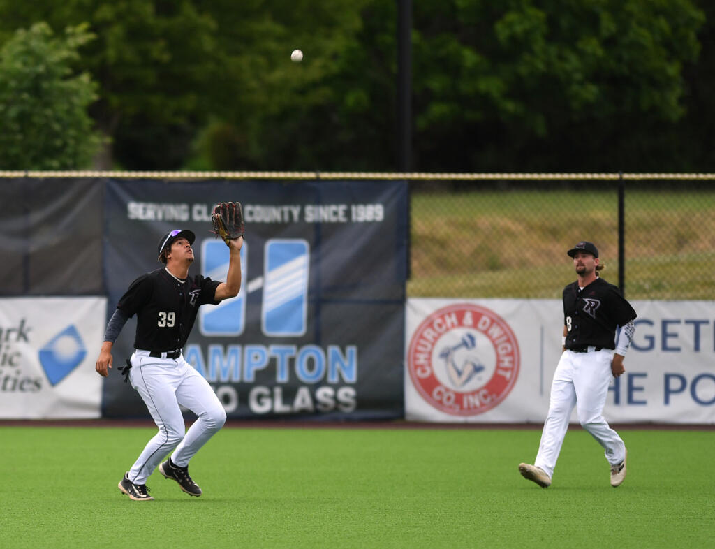 Raptors outfielder Quincy Scott, left, catches a ball Friday, June 16, 2023, during the Raptors’ game against Cowlitz at the Ridgefield Outdoor Recreation Complex.