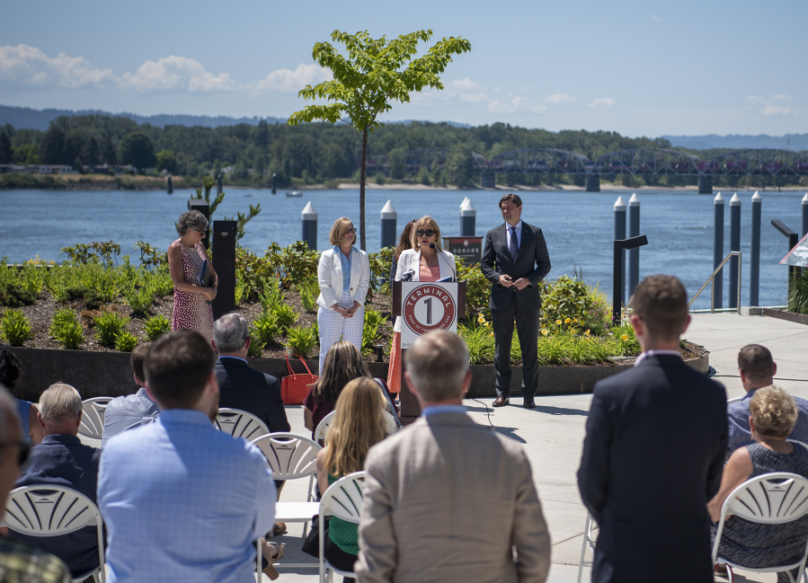 A crowd listens to Washington State Rep. Sharon Wylie, center, talk about the work to expand the state's tax increment financing law so it could be used by the Port of Vancouver. The local lawmaker spoke during a press conference Monday at Terminal 1 on the Vancouver waterfront.