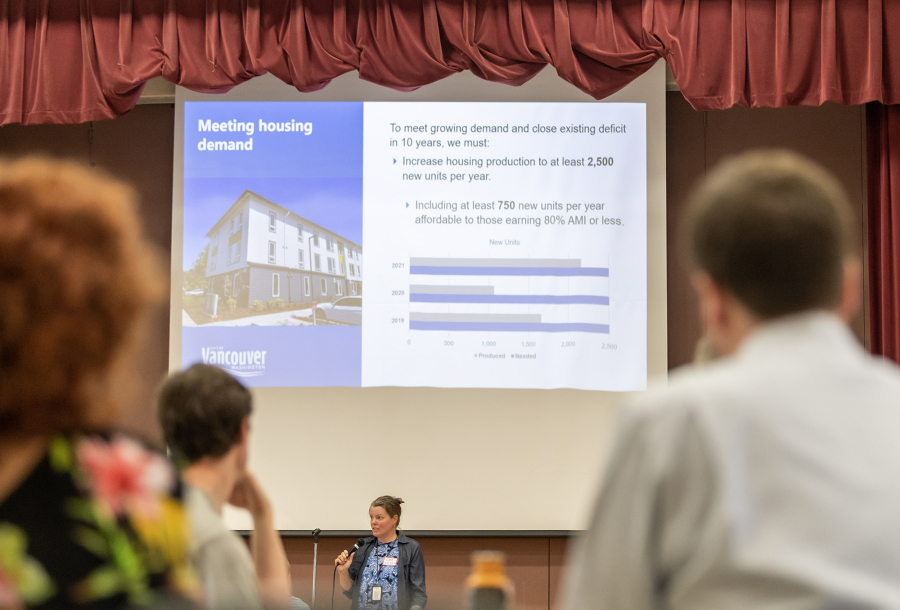 A crowd listens to a presentation from City of Vancouver Housing Programs Manager Samantha Whitley Monday during a community forum at Eleanor Roosevelt Elementary School.