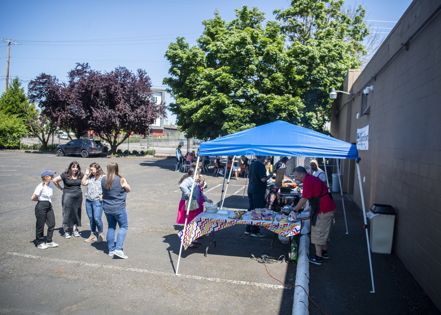 Taylor Balkom/The Columbian 
 Columbian employees enjoy a hot-dog barbecue at the newspaper office on Thursday.