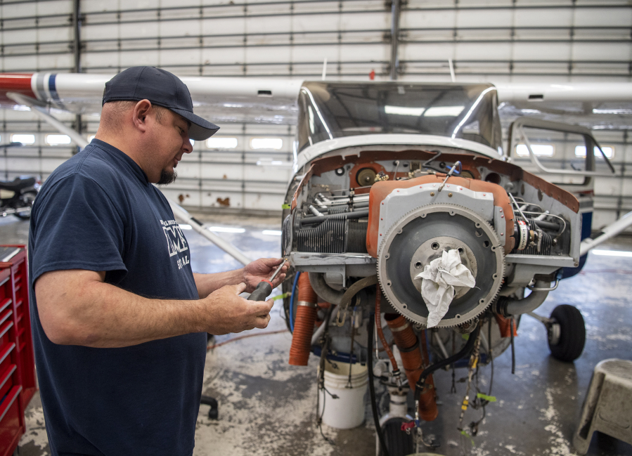 Director of maintenance Jason Cochran works on the front of an airplane at Pearson Field. Clark County's regional airports directly contribute millions of dollars in business revenues to the local economy, according to a study from the Washington State Department of Transportation.