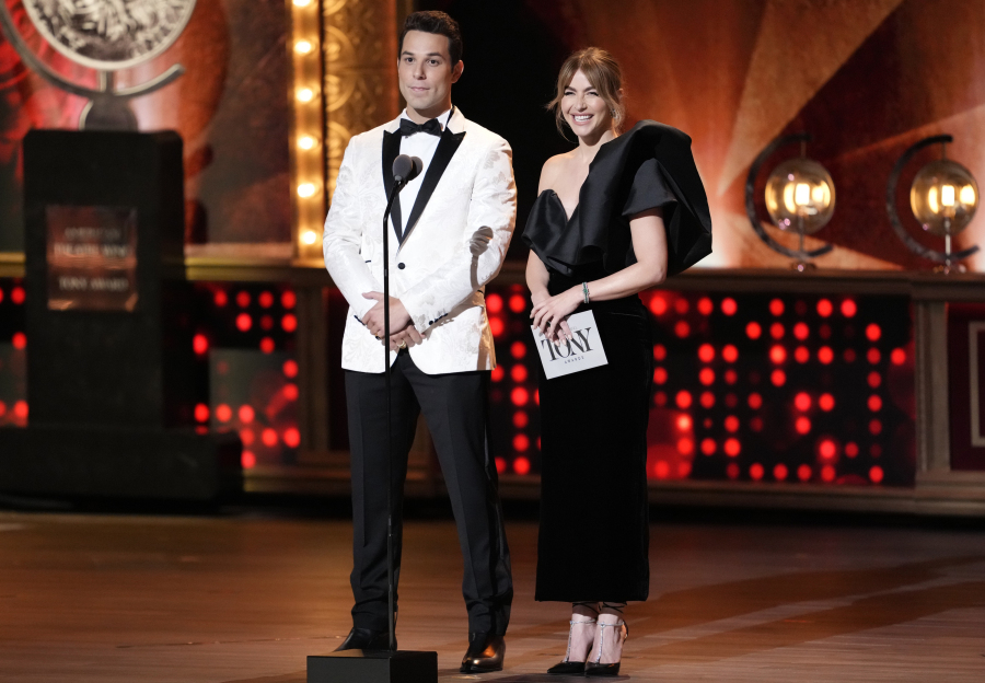 Hosts Skylar Astin, left, and Julianne Hough speak on stage at the 76th annual Tony Awards on Sunday, June 11, 2023, at the United Palace theater in New York.
