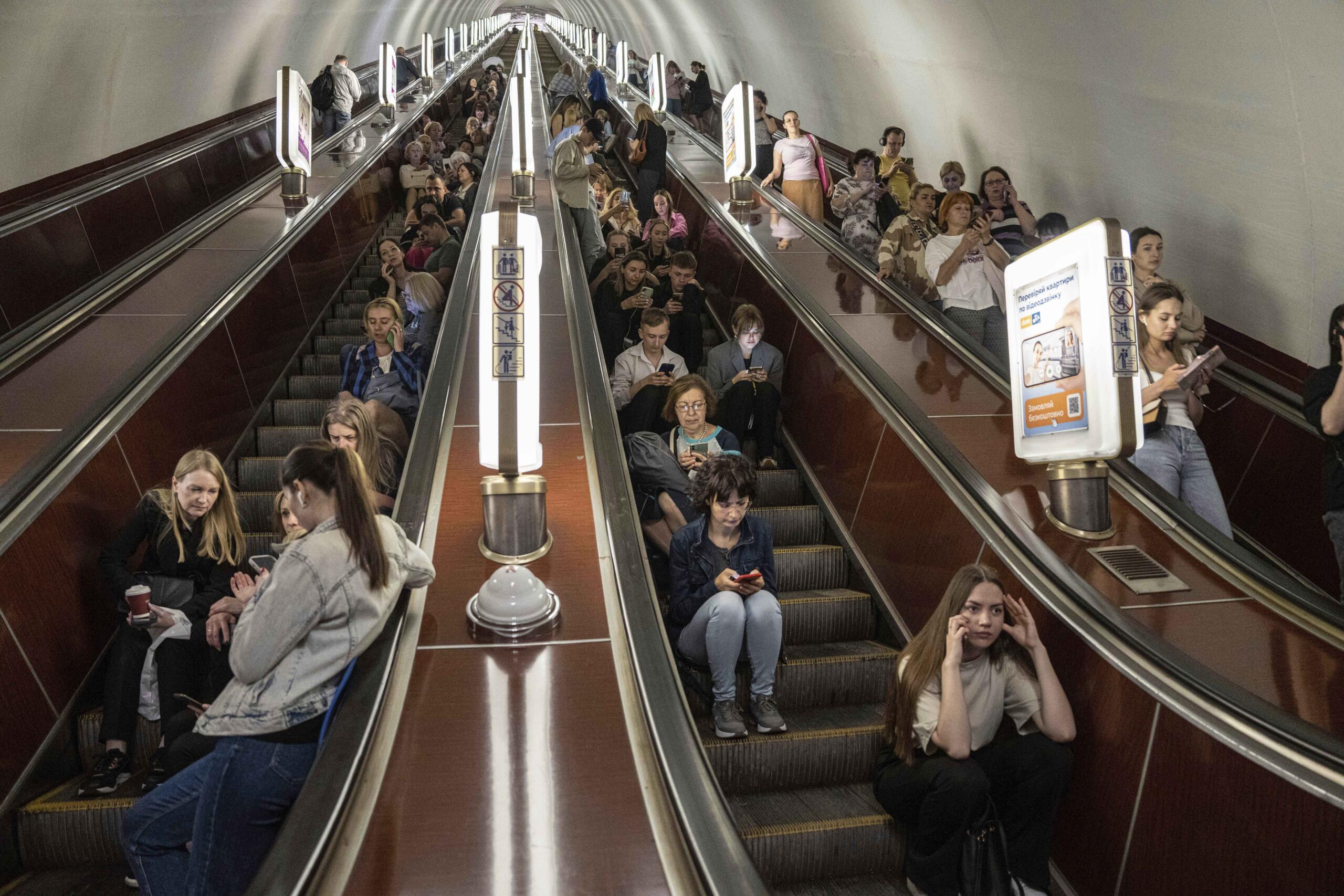 People take cover at a metro station during a Russian rocket attack in Kyiv, Ukraine, Monday, May 29, 2023.