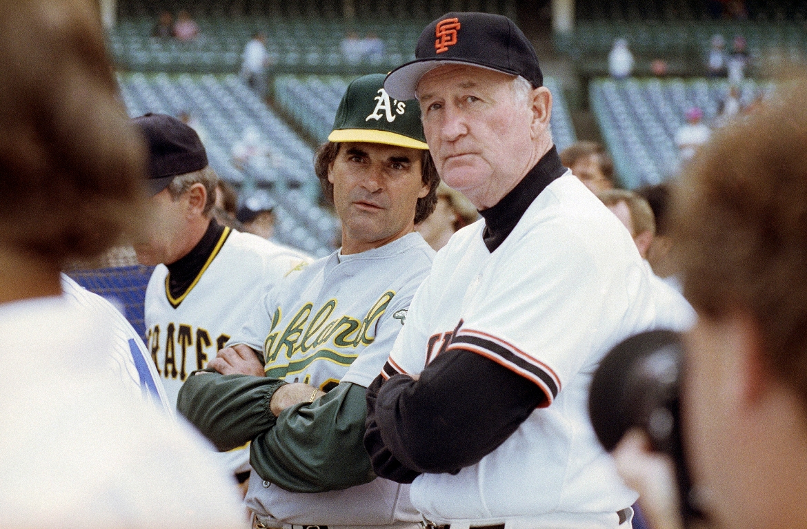 American League manager Tony La Russa, center left, from the Oakland A's, and National League manager Roger Craig, of the San Francisco Giants, watch batting practice at Wrigley Field in Chicago, July 10, 1990, before the start of the 61st All-Star Game. Craig, who pitched for three championship teams during his major league career and then managed the San Francisco Giants to the 1989 World Series that was interrupted by a massive earthquake, died Sunday, June 4, 2023. He was 93.