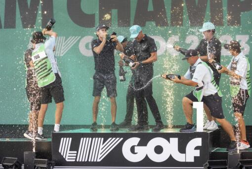 Team champions David Puig, Sebastián Muñoz, Mito Pereira, Captain Joaquín Niemann of Torque GC and their caddies celebrate on stage with the team trophy during LIV Golf DC at the Trump National Golf Club in Washington Sunday, May 28, 2023, in Sterling, Virginia. The most disruptive year in golf ended Tuesday, June 6, 2023, when the PGA Tour and European tour agreed to a merger with Saudi Arabia's golf interests, creating a commercial operation designed to unify professional golf around the world.