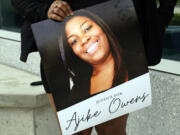 A protester, holds a poster of Ajike Owens at the Marion County Courthouse, Tuesday, June 6, 2023, in Ocala, demanding the arrest of a woman who shot and killed Owens, a 35-year-old mother of four, last Friday night, June 2. Authorities came under intense pressure Tuesday to bring charges against a white woman who killed Owens, a Black neighbor, on her front doorstep, as they navigated Florida’s divisive stand your ground law that provides considerable leeway to the suspect in making a claim of self defense.