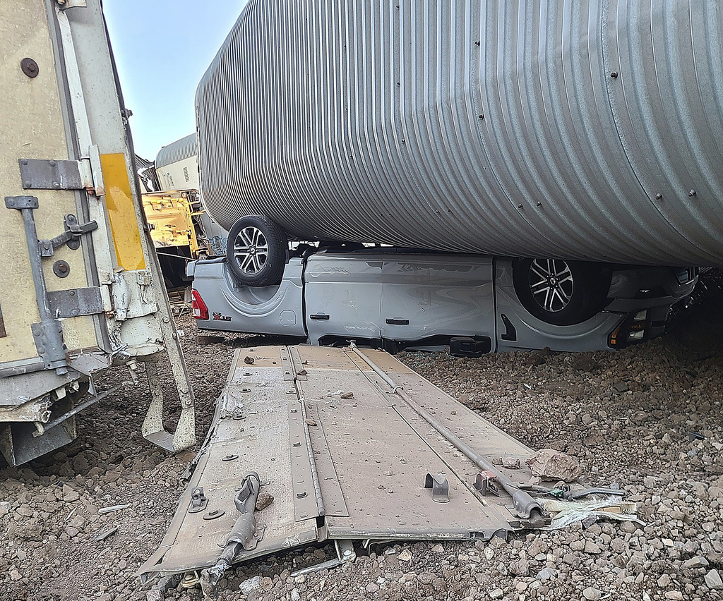This image provided by the Coconino County Emergency Management shows a vehicle damaged as a result of a freight train derailment, Wednesday, June 7, 2023 east of Williams, Ariz.