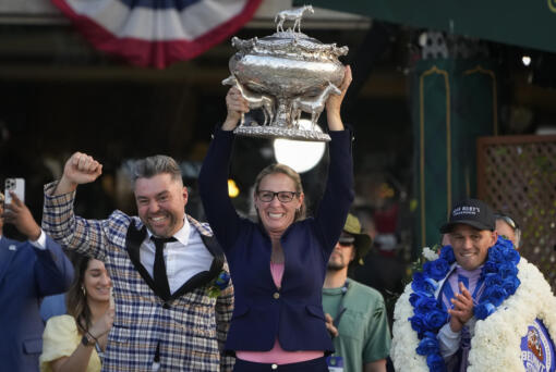 Trainer Jena Antonucci, center, hoists up the August Belmont Trophy alongside jockey Javier Castellano, right, and owner Jon Ebbert, left, after their horse Arcangelo won the 155th running of the Belmont Stakes horse race, Saturday, June 10, 2023, at Belmont Park in Elmont, N.Y.
