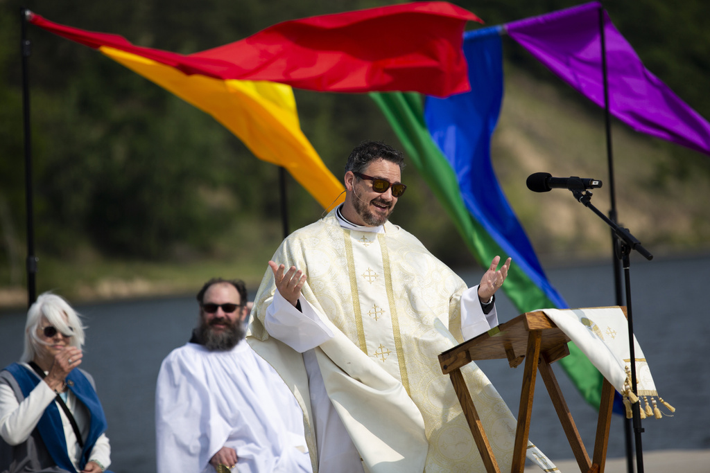 Rev. Dr. Jared Cramer of St. John's Episcopal Church and clergy members are seen during a pride worship service at the Lynne Sherwood Waterfront Stadium in Grand Haven, Mich., on Saturday, June 10, 2023. The festival — which organizers had hoped would attract at least 500 attendees — drew thousands of people from all over who came to experience the first-time event's drag show, dance party and vendor-filled streets.