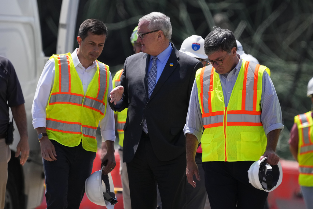 Transportation Secretary Pete Buttigieg, left, meets with Philadelphia Mayor Jim Kenney at the scene of a collapsed elevated section of Interstate 95, in Philadelphia, Tuesday, June 13, 2023.