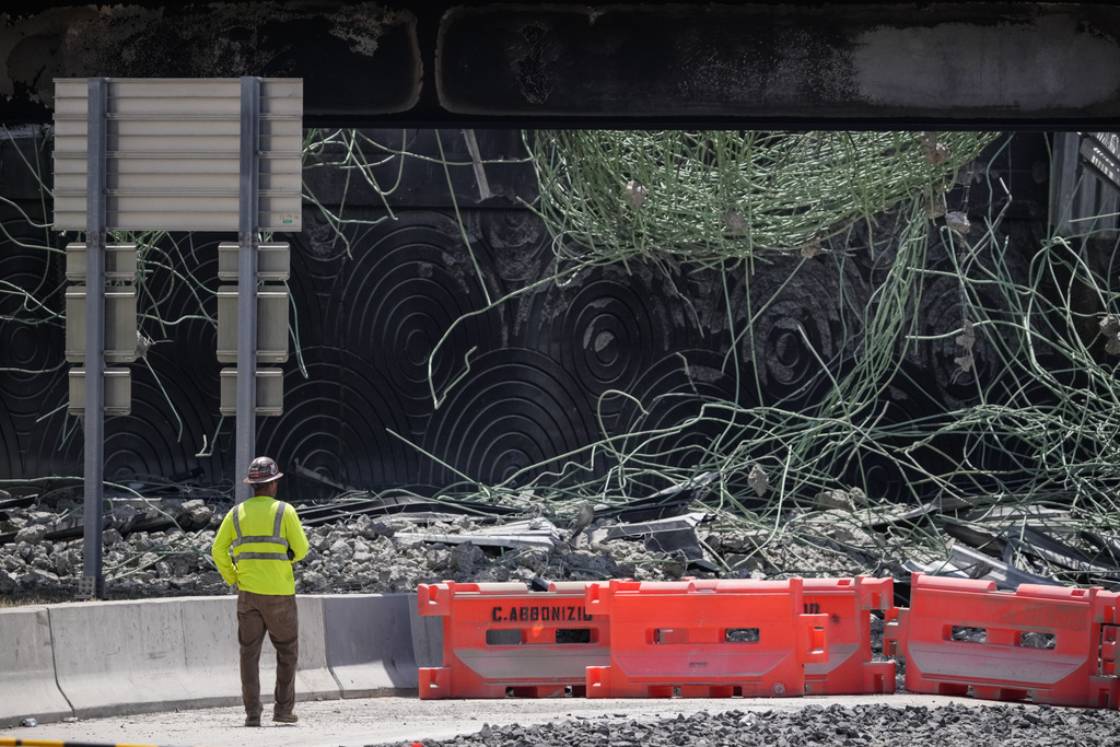 A person views the scene of a collapsed elevated section of Interstate 95, Tuesday, June 13, 2023, in Philadelphia.