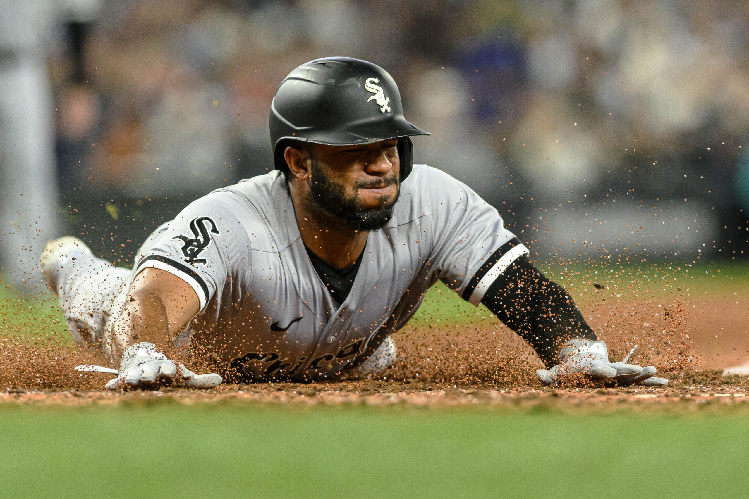Chicago White Sox's Elvis Andrus slides home to score off a single by Zach Remillard during the ninth inning of a baseball game against the Seattle Mariners, Saturday, June 17, 2023, in Seattle.