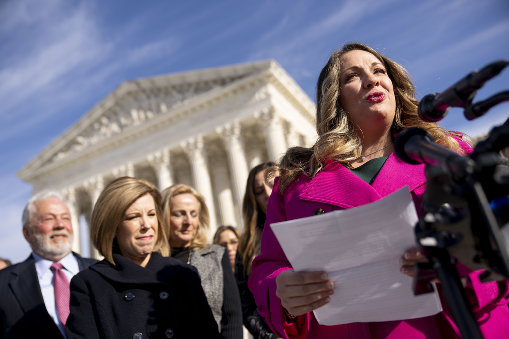 FILE - Lorie Smith, a Christian graphic artist and website designer in Colorado, right, accompanied by her lawyer, Kristen Waggoner of the Alliance Defending Freedom, second from left, speaks outside the Supreme Court in Washington, Monday, Dec. 5, 2022, after her case was heard before the Supreme Court.