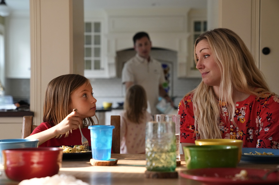 OB-GYN Dr. Kylie Cooper sits at the dinner table with her daughter, Hazel, Thursday, June 15, 2023, in Minnesota. The family is settling into the new house after moving. They're figuring out new schedules and looking for new friends.