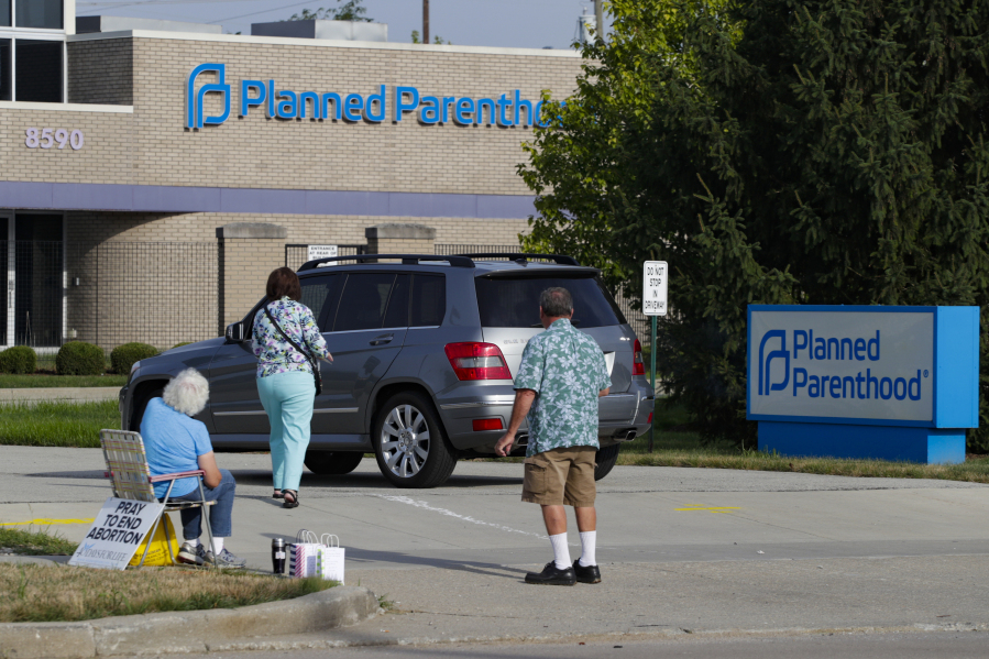 Abortion protesters attempt to hand out literature Aug. 16, 2019, at a Planned Parenthood clinic in Indianapolis. Planned Parenthood is shifting funding to its state affiliates and cutting national office staff to reflect a changed landscape in both how abortion is provided and how battles over access are playing out.
