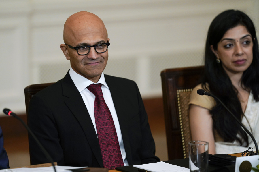 Satya Nadella, CEO of Microsoft, left, and Vrinda Kapoor, co-founder of 3rdiTech, listen during a meeting with President Joe Biden, India's Prime Minister Narendra Modi and other American and Indian business leaders in the East Room of the White House, Friday, June 23, 2023, in Washington.