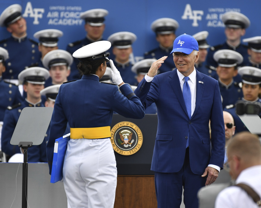 A Cadet receives her diploma as she salutes President Joe Biden during the United States Air Force Academy graduation ceremony Thursday, June 1, 2023, at Air force Academy, Colo.